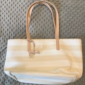Kate Spade tote with cream and white bold stripes with nude straps, gold charm.